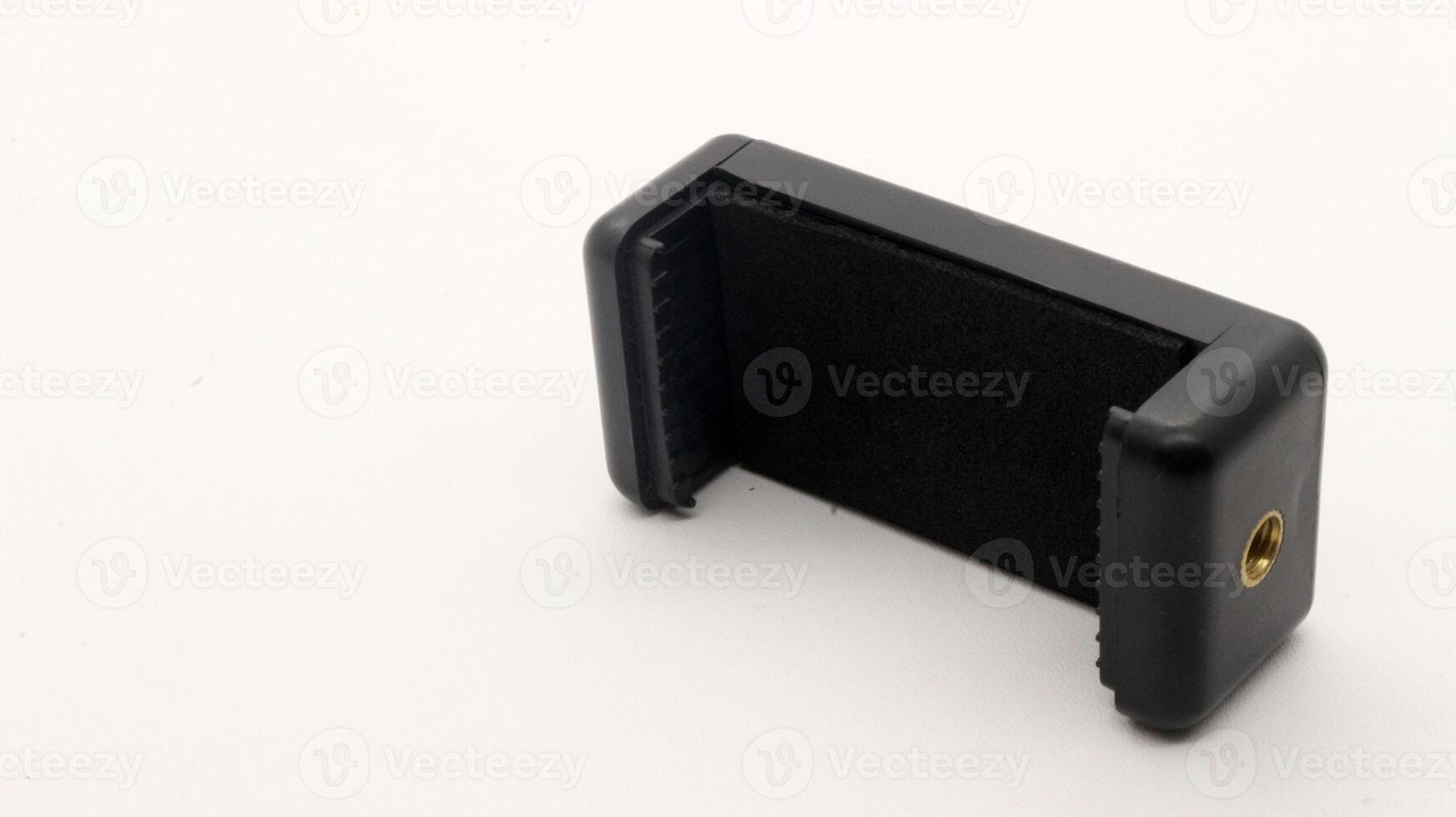 Tripod U holder for smart phone and camera isolated photo