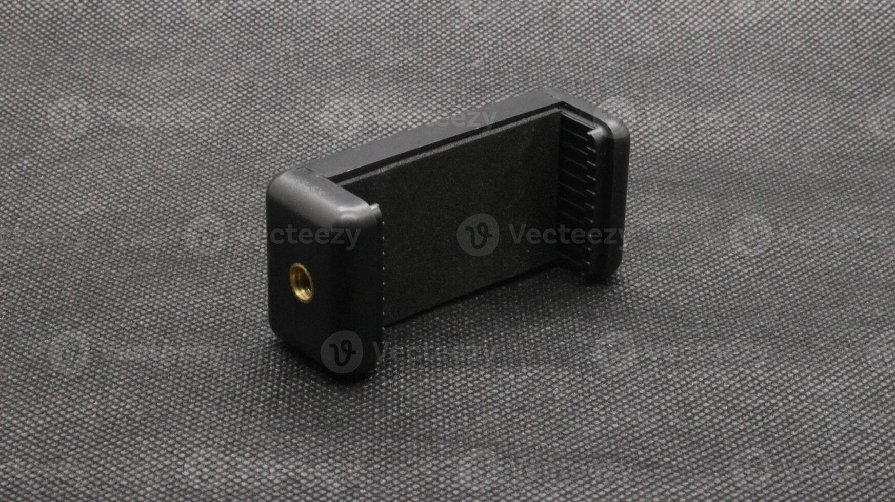 Tripod U holder for smart phone and camera isolated photo