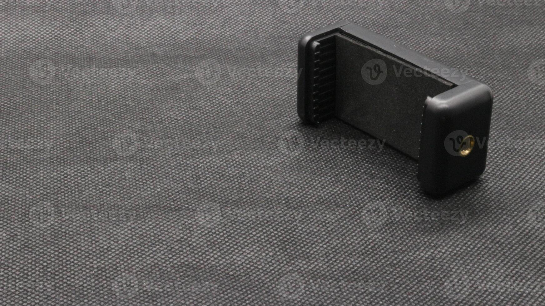 Tripod U holder for smart phone and camera isolated photo