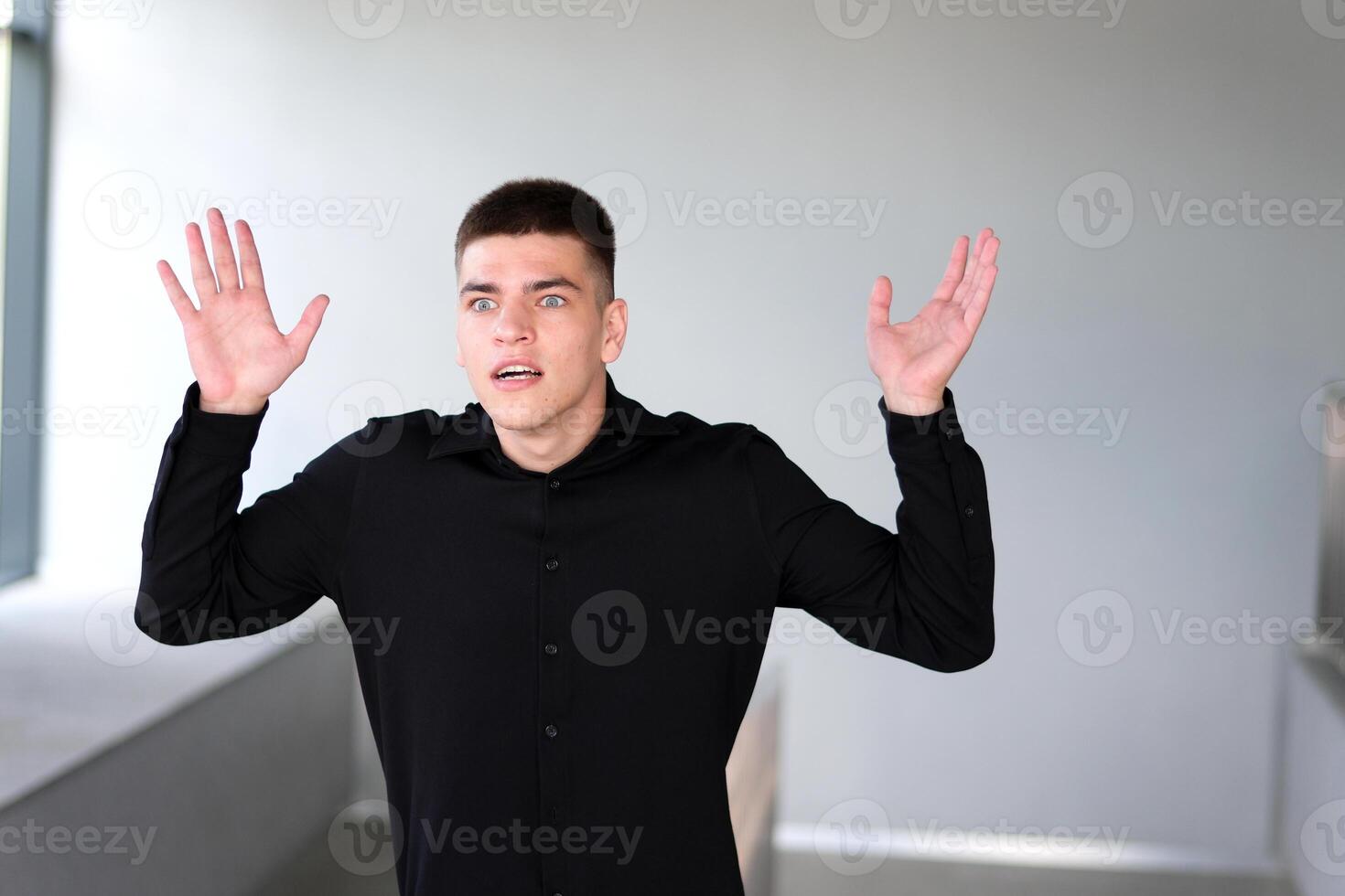 Surprise joy man grabs his head raises his eyes up unreal Unbelievable. Close up portrait of young amazed guy shouting and grabbing head in amazement, can't believe his fortune and win photo