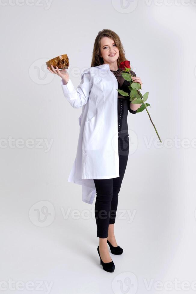 Holding a skull in your hands. Close-up portrait of a female face in a death mask. Halloween Costume party holding a skull in your hands photo