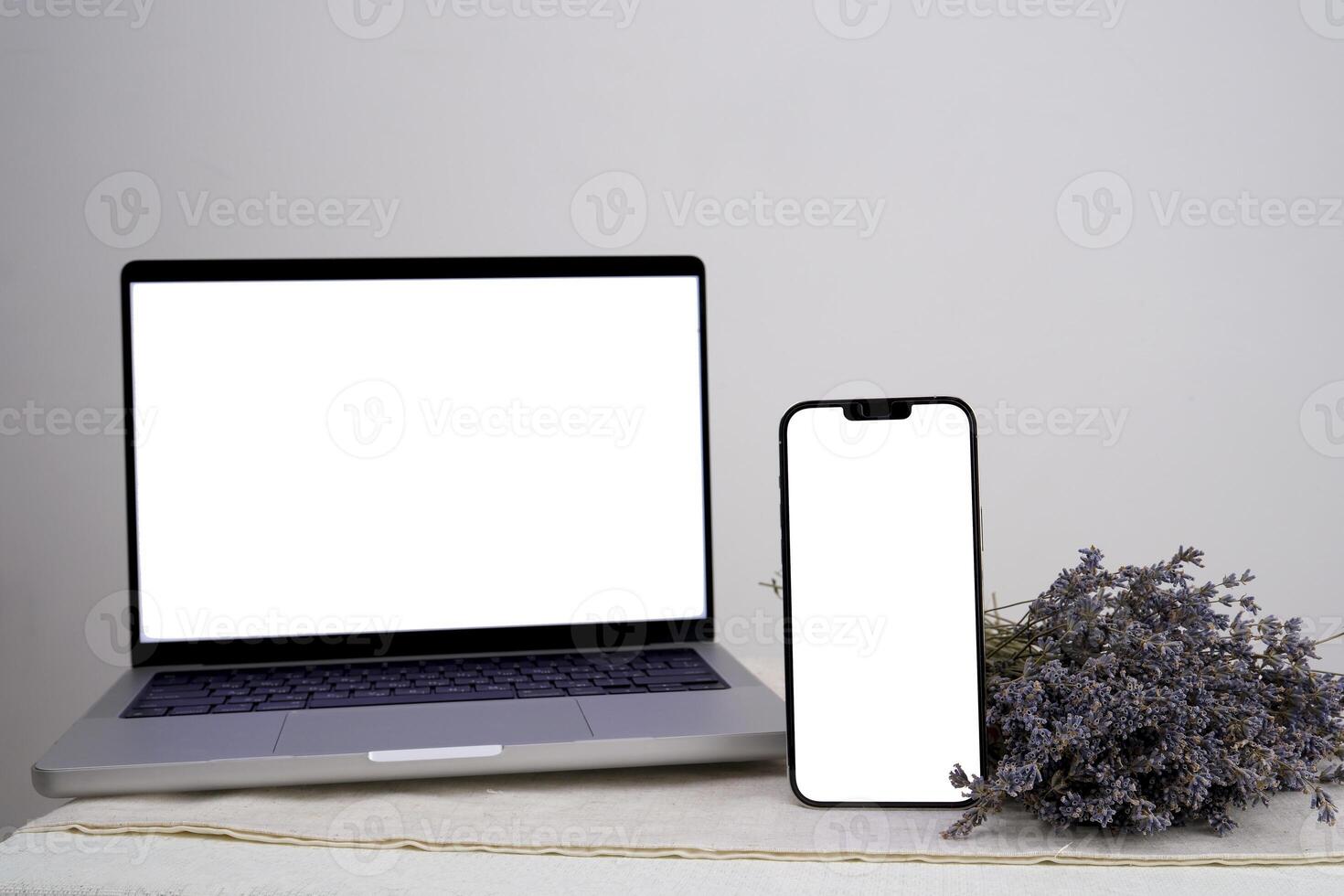 Bouquet of dry lavender Computer, laptop and smartphone, display. on white background workspace mock up design. photo