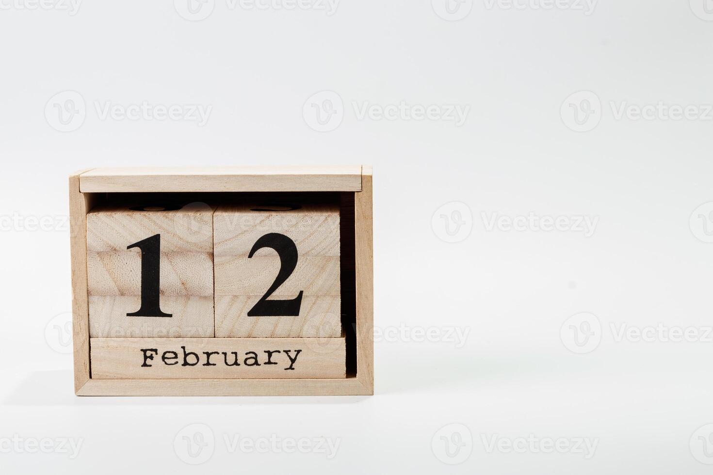 Wooden calendar February 12 on a white background photo
