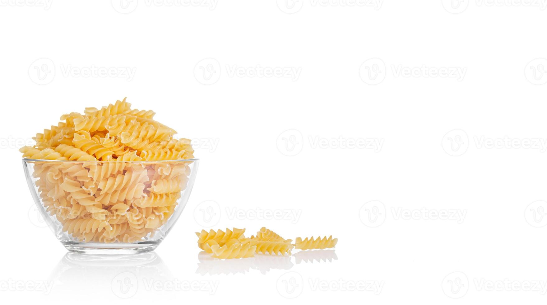 Pasta products in the form of a spiral on a plate, texture, on a white background photo