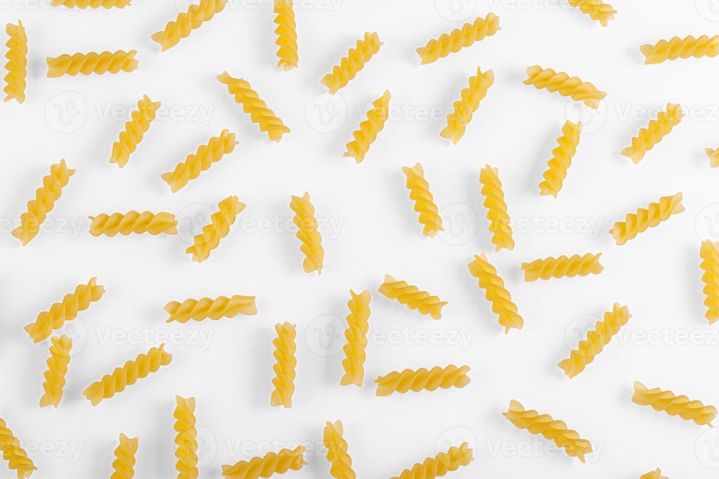 Pasta products in the form of a spiral, texture, on a white background photo