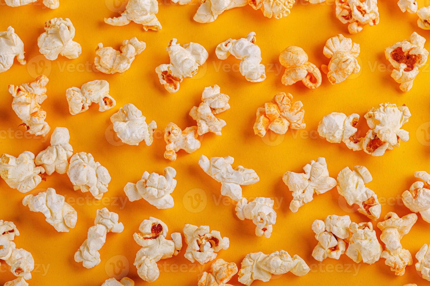 box with popcorn on a yellow background photo