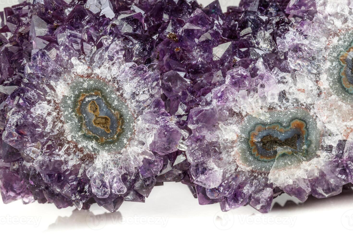 Macro mineral stone Amethyst eye, in the form of an owl on a white background photo