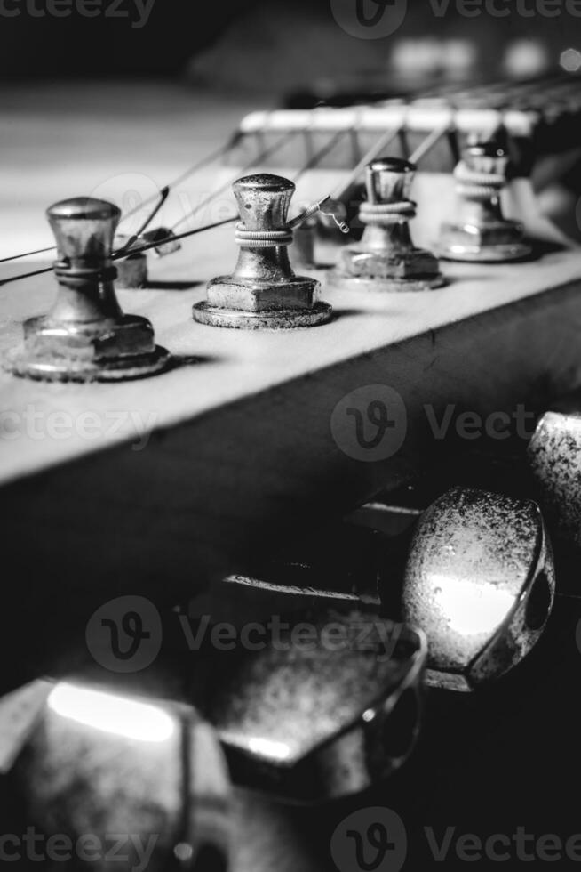 Close up from an old vintage guitar headstock , Full with dust. In black and white. photo