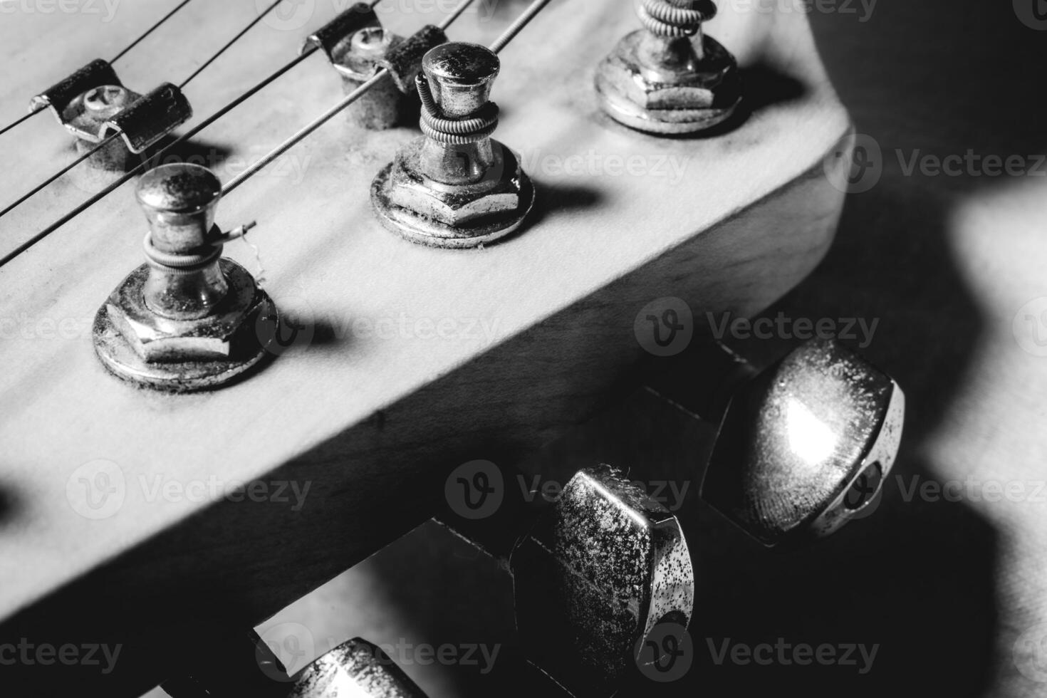 Close up from an old vintage guitar headstock , Full with dust. In black and white. photo