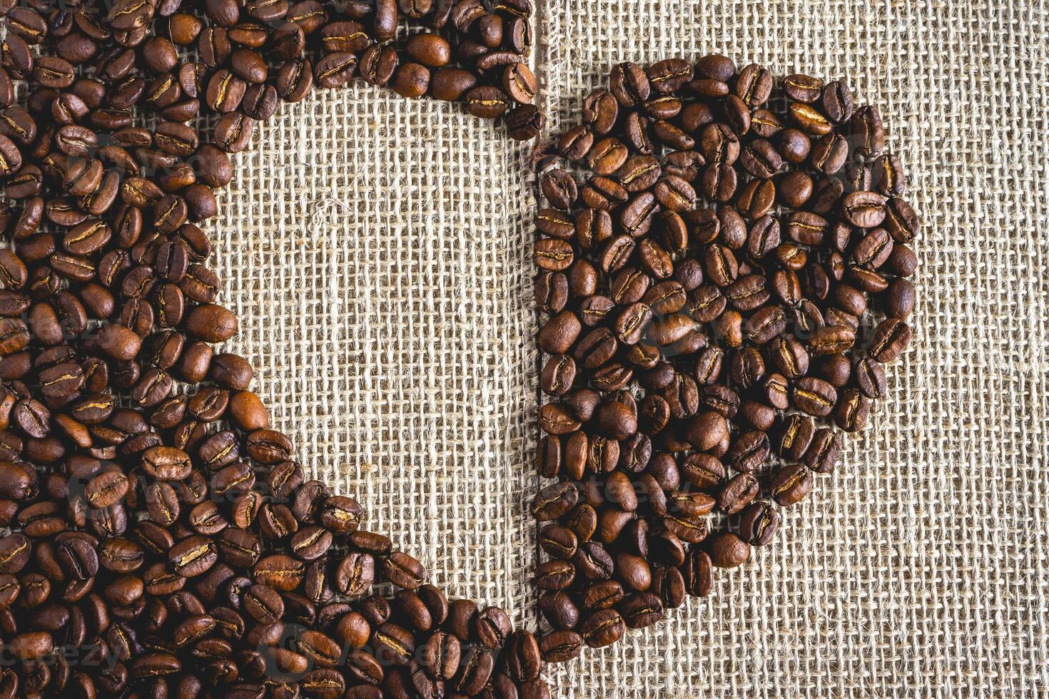 Coffee beans laying down in a heart shape, On a Burlap fabric. Background voor coffee related products. photo