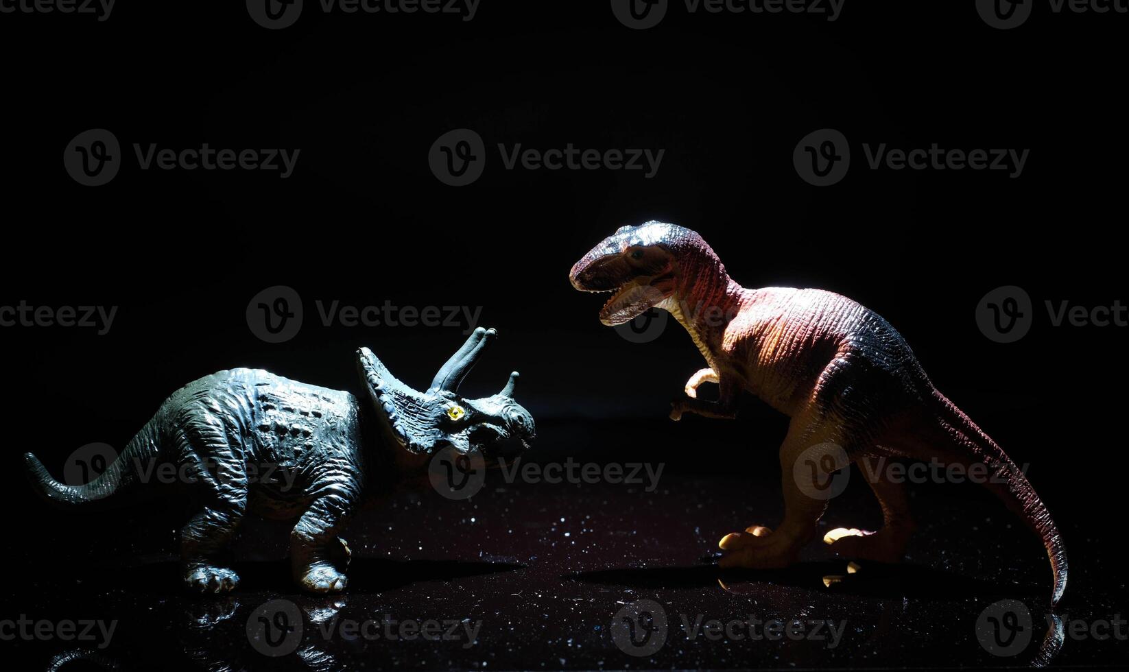 two dinosaurs, a tyrannosaurus rex and a triceratops fight in a realistic prehistoric setting illuminated by the moon photo