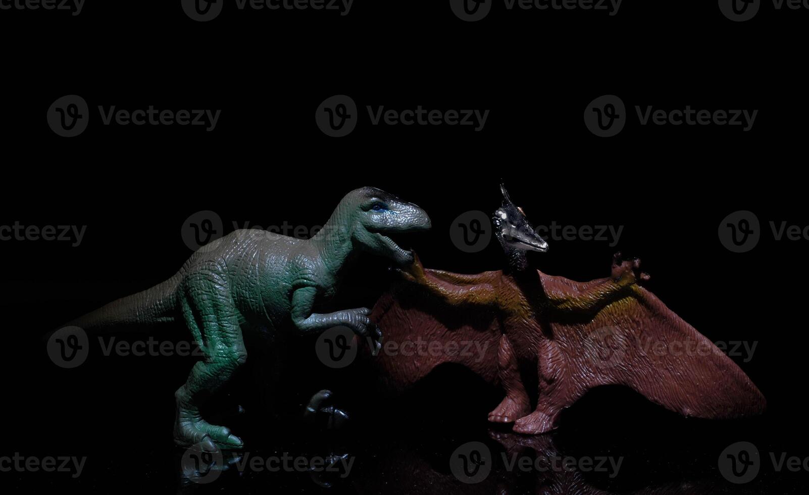 two dinosaurs, a velociraptor and a pterodactyl fight in a prehistoric scenario in a realistic way photo
