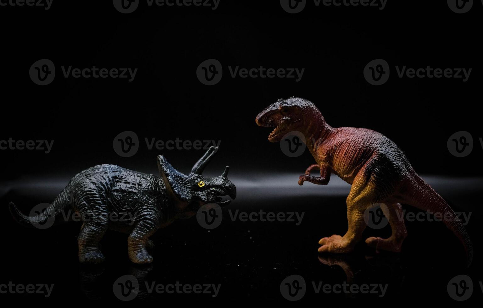 two dinosaurs, a tyrannosaurus rex and a triceratops fight in a realistic prehistoric setting illuminated by the moon photo