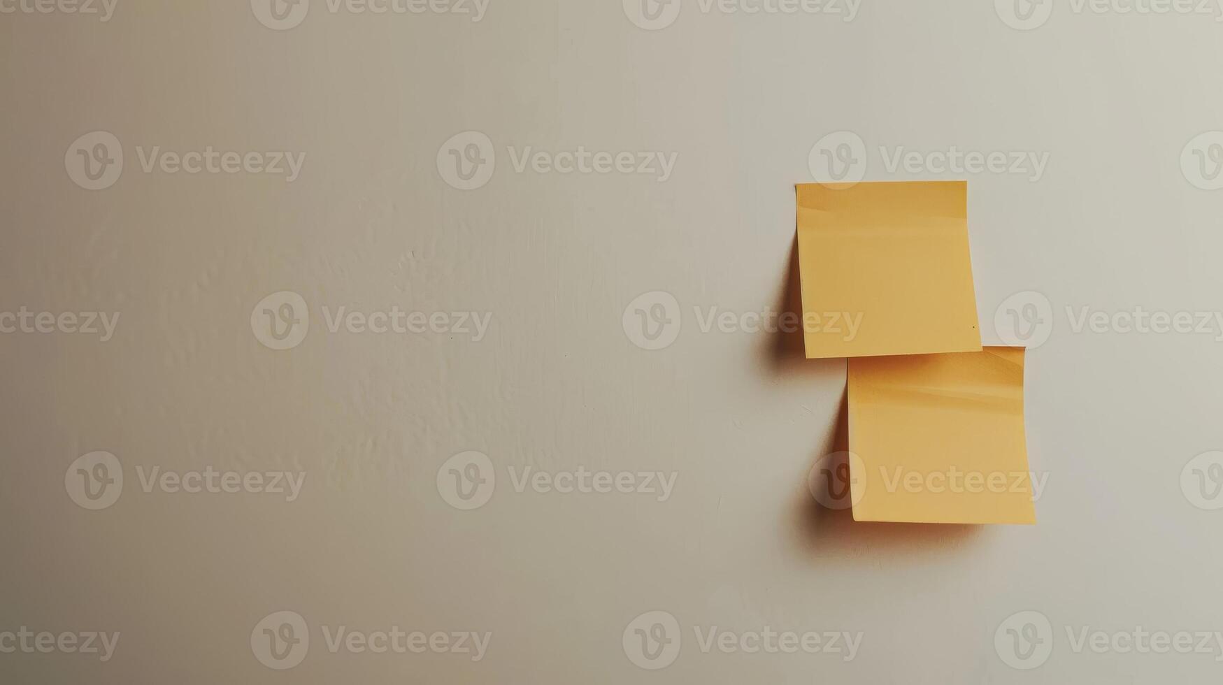 Blank yellow paper taped to the wall for writing messages. photo
