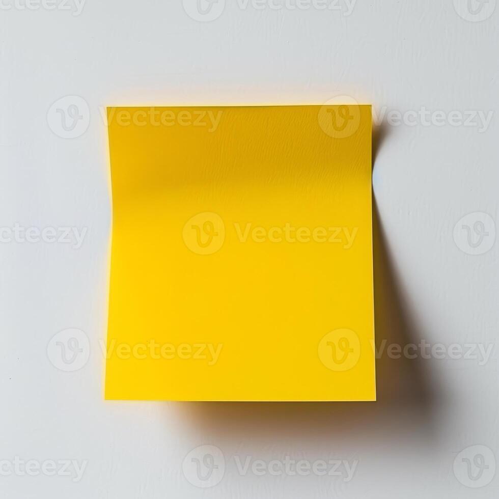 Blank yellow paper taped to the wall for writing messages. photo