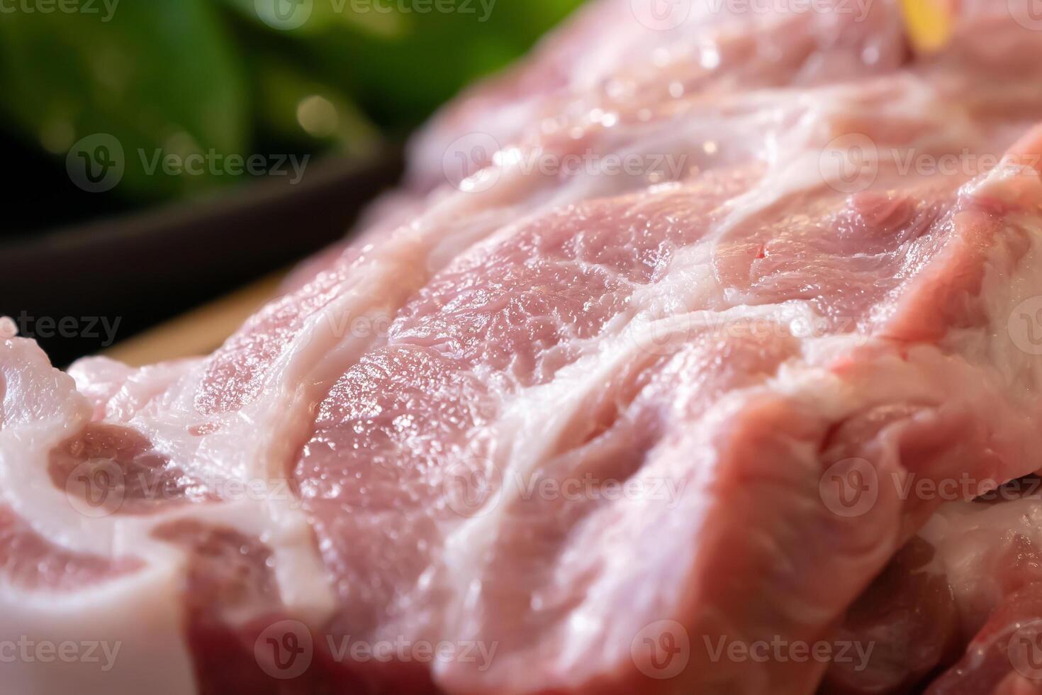 Close up macro shooting sliced pork meat on wood plate in studio light. photo