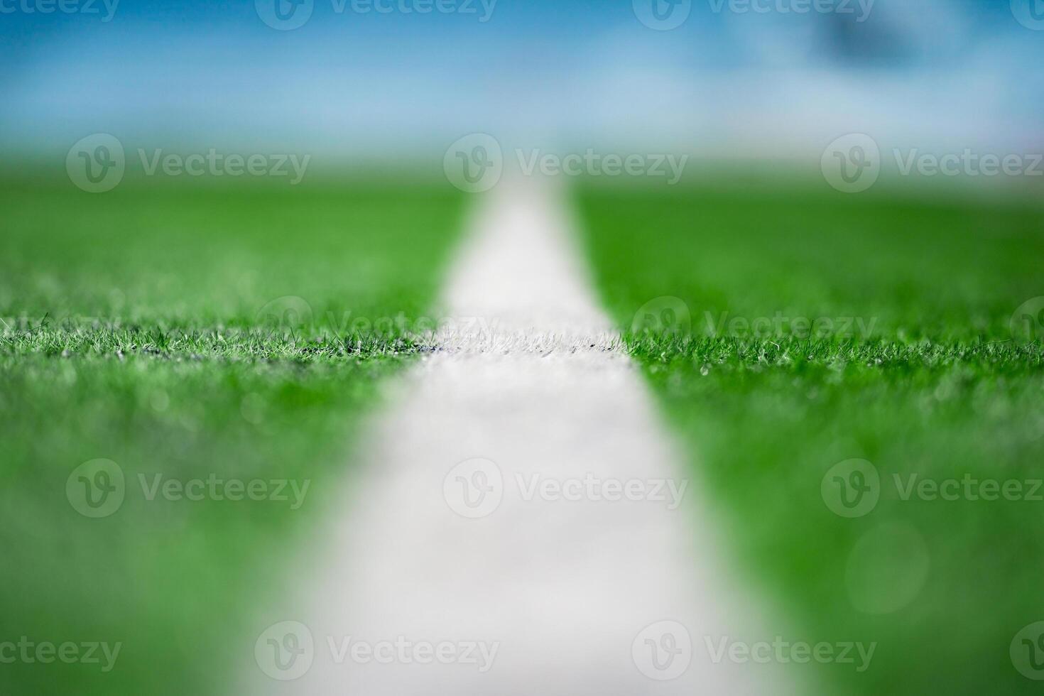 Close up to the White Touch Line of Green Artificial Grass Turf Outdoor on green soccer field. photo