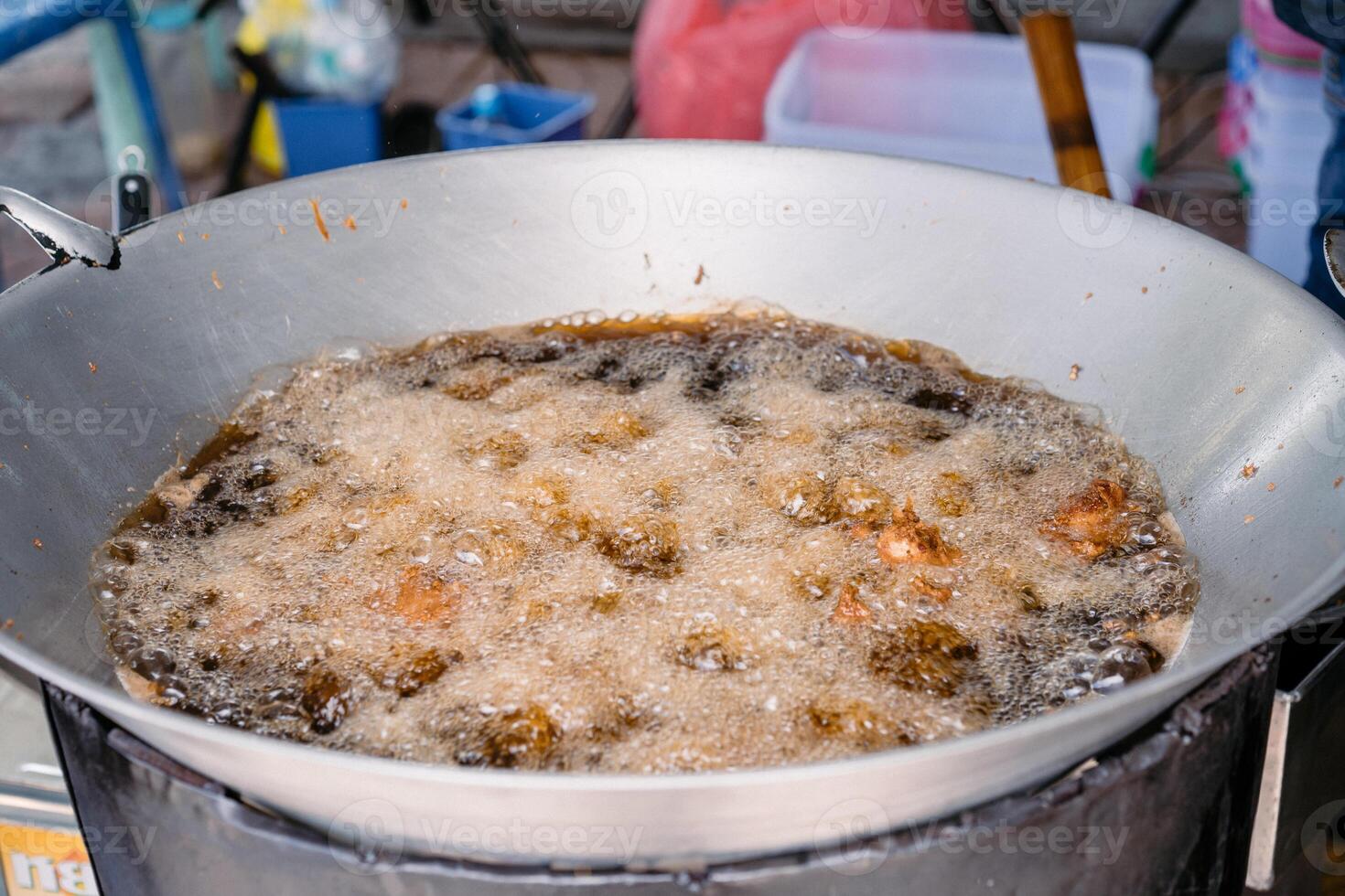 Asian Fried Chicken are fried by palm oil in the large pan. photo