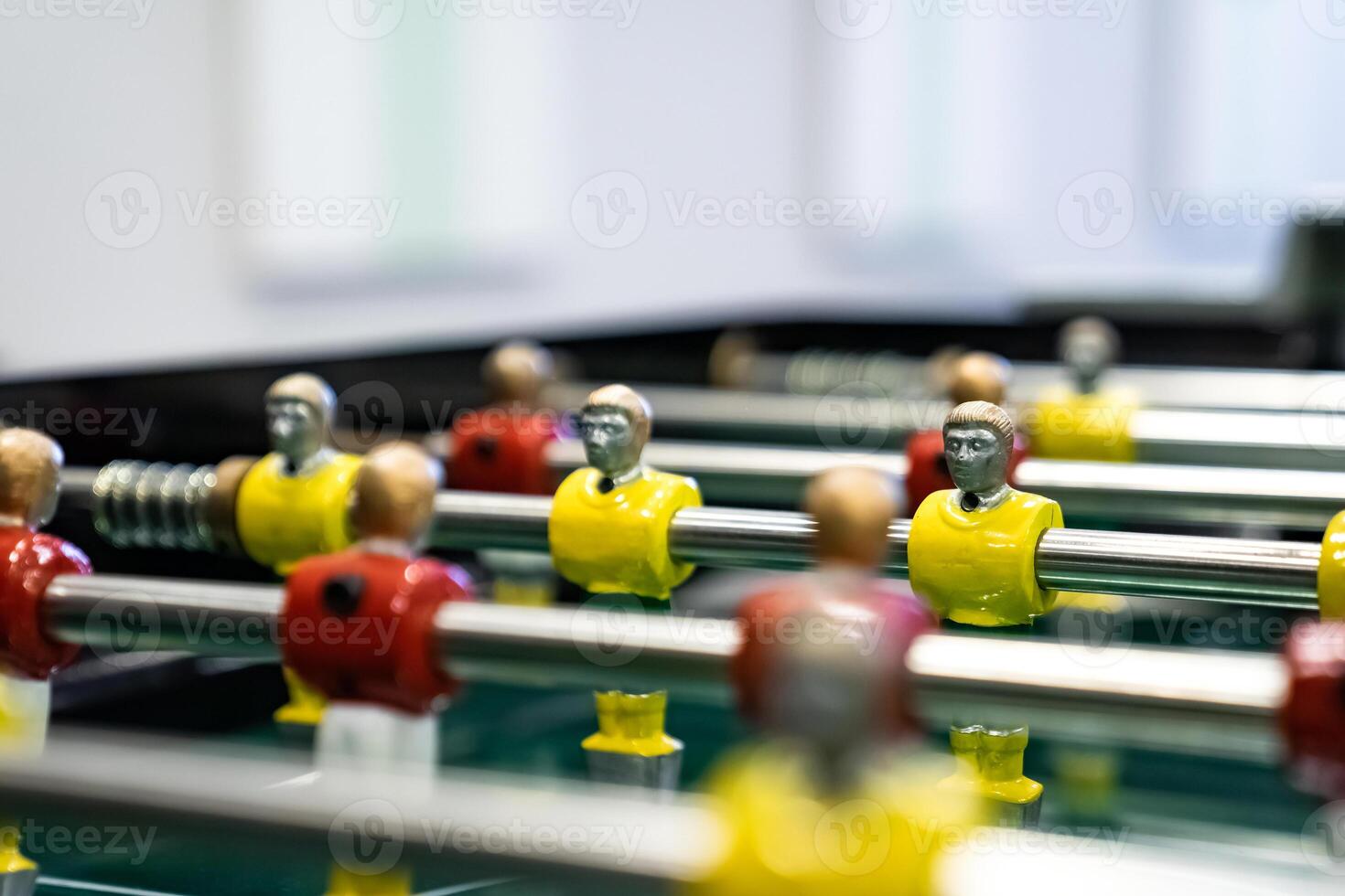 football table game in which players are divided into two teams with different colors, red and yellow. photo