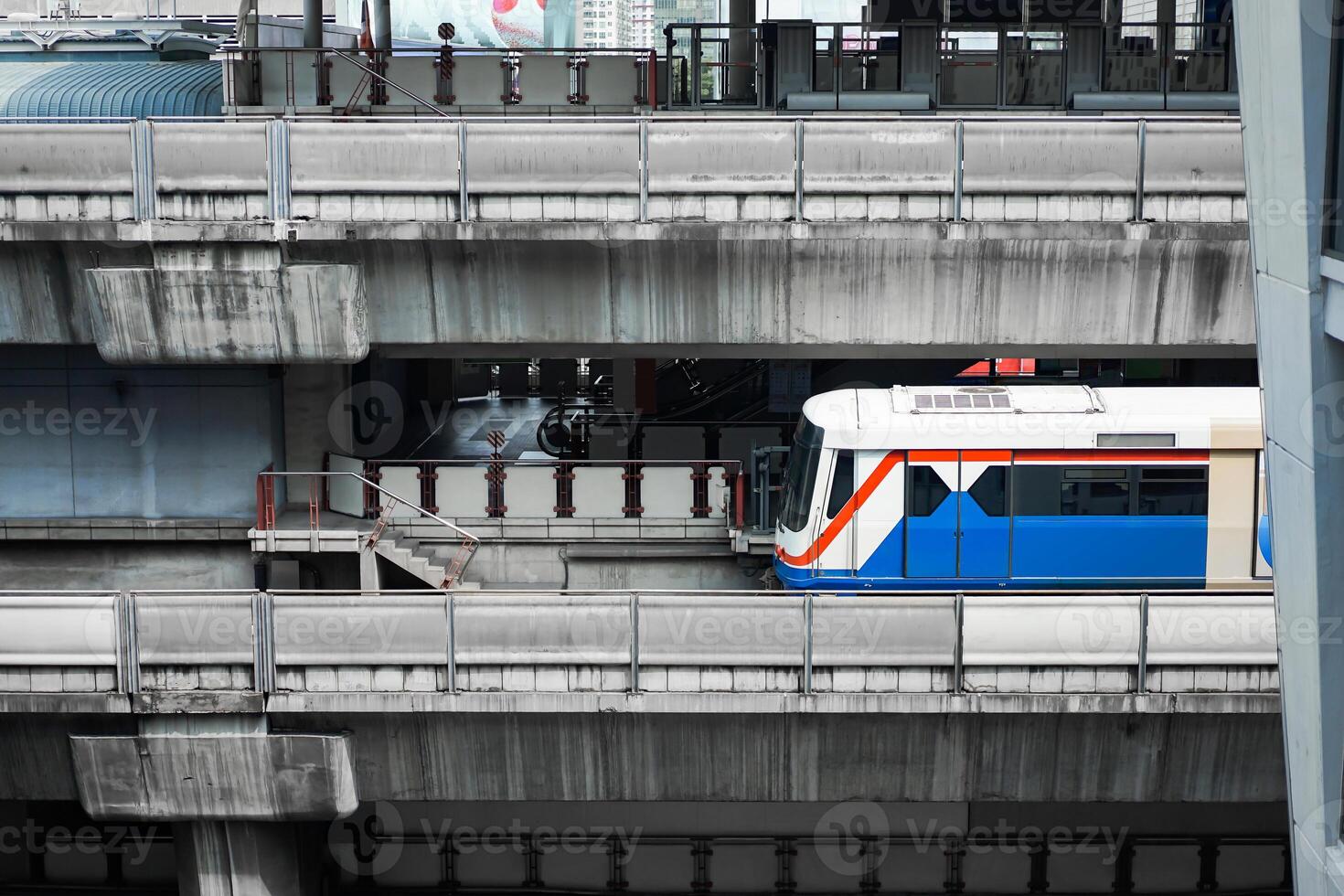 Bangkok Mass Transit System BTS in close up section view is driven across the Siam Square Station from Siam Square One Building view. Bangkok, Thailand. photo