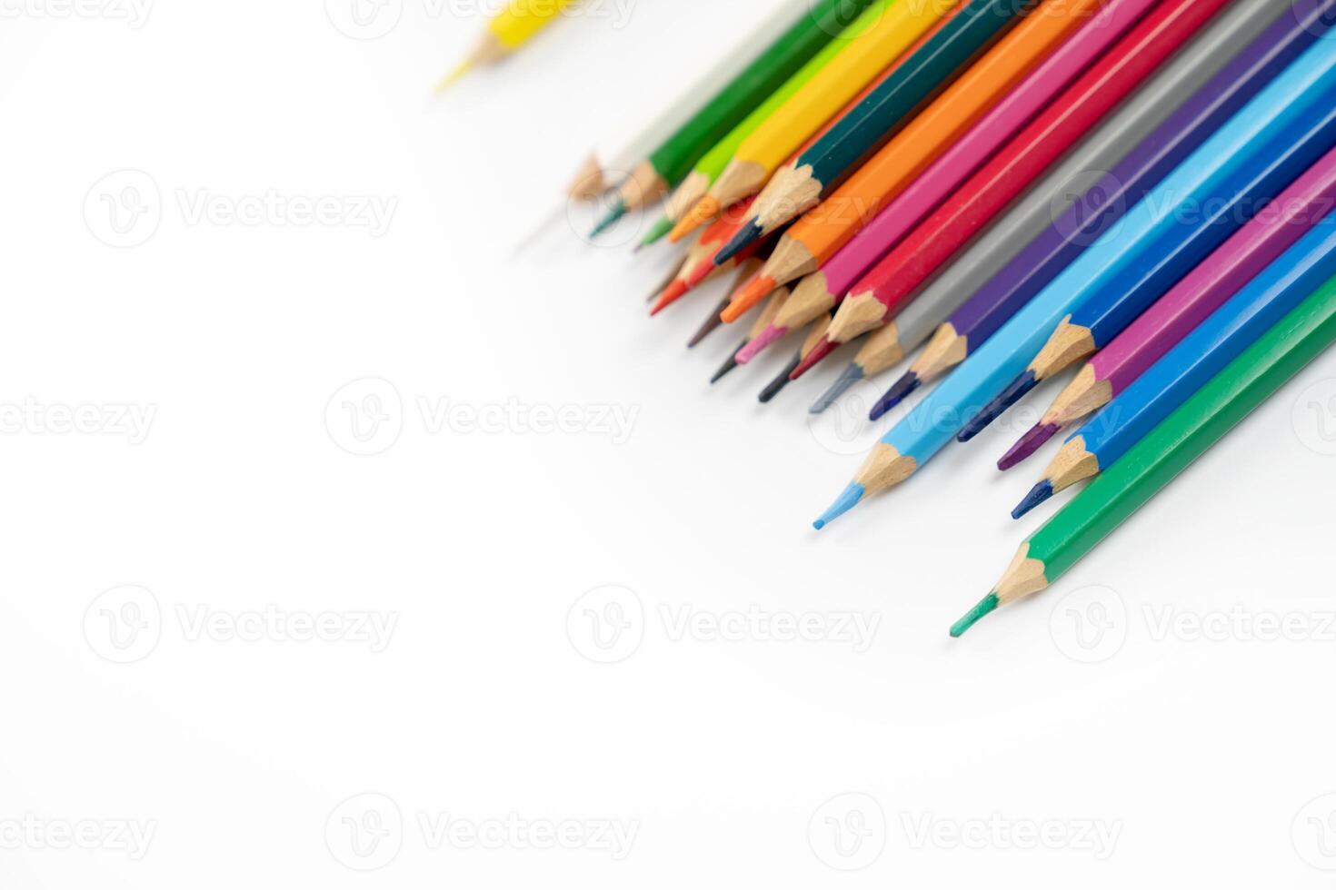 blunt colour pencils are arranged in the line on the white background and ready to paint. photo