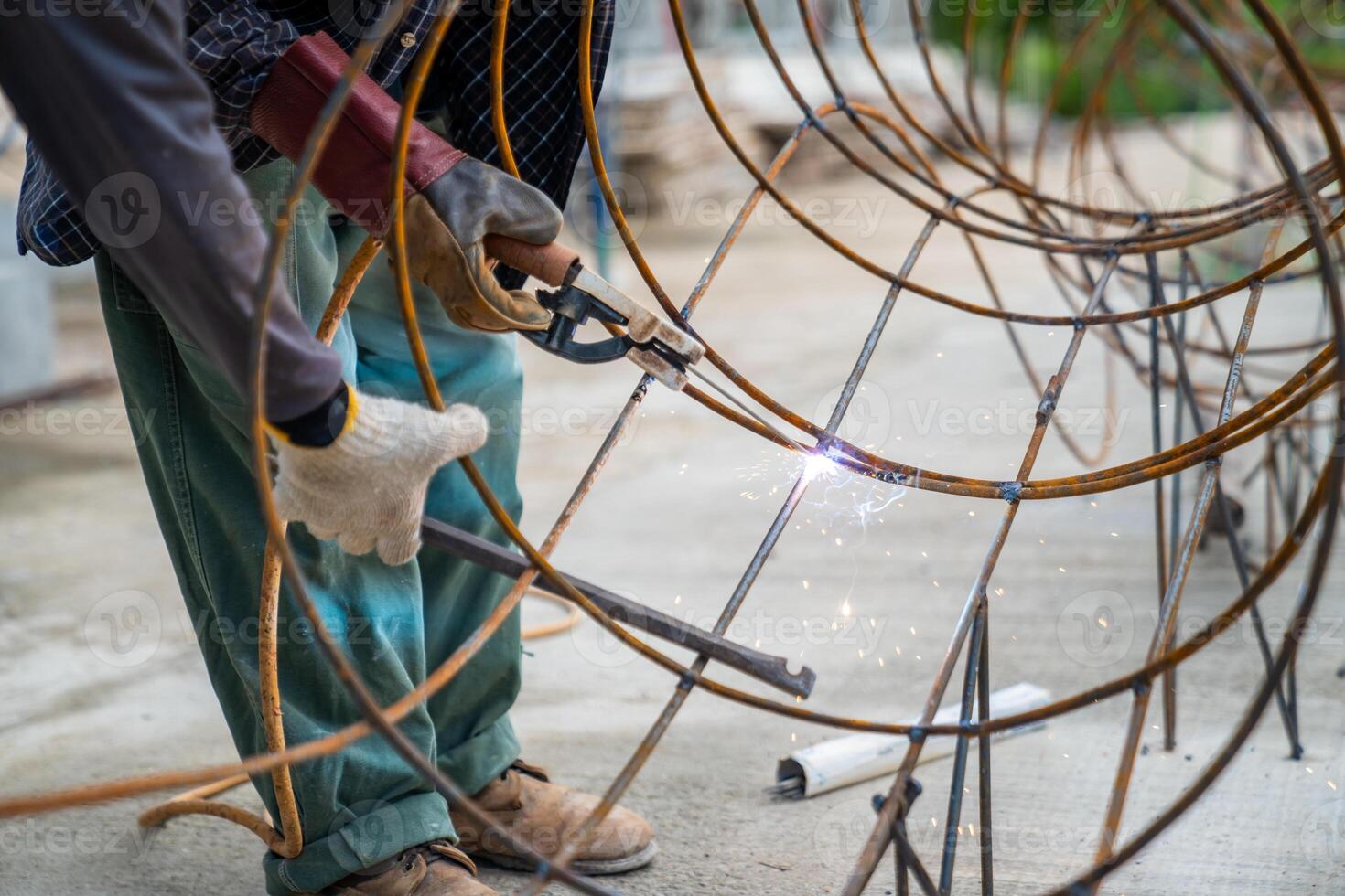 Blacksmith Technicians are welding several curve wires to form a structure. photo