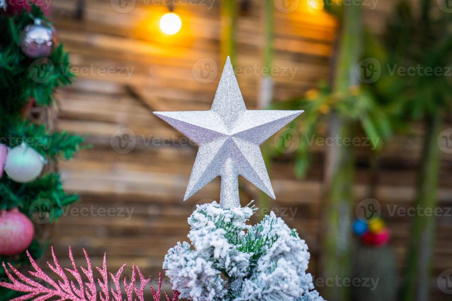 Christmas Tree with snowflake is decored with ball, presents and gift in pink theme for Christmas and new year event photo