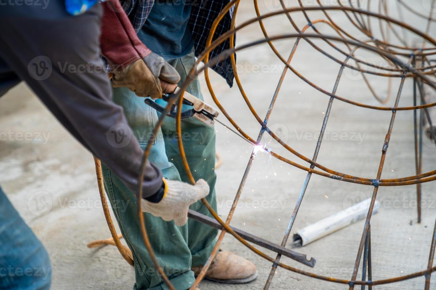 Blacksmith Technicians are welding several curve wires to form a structure. photo