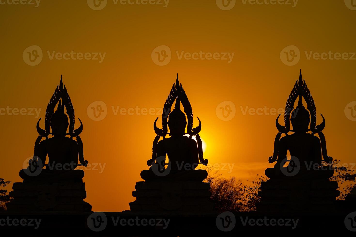 Silhouette Buddha statue between creating and building process, at outdoor field with the sun set and twilight period time., Thailand. photo