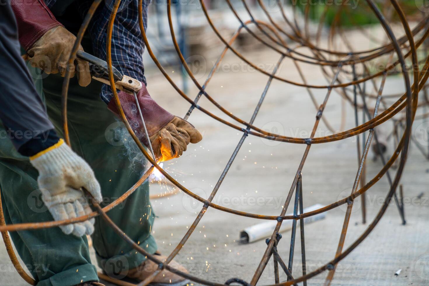 Blacksmith Technicians are welding several curve wires to form a structure. photo