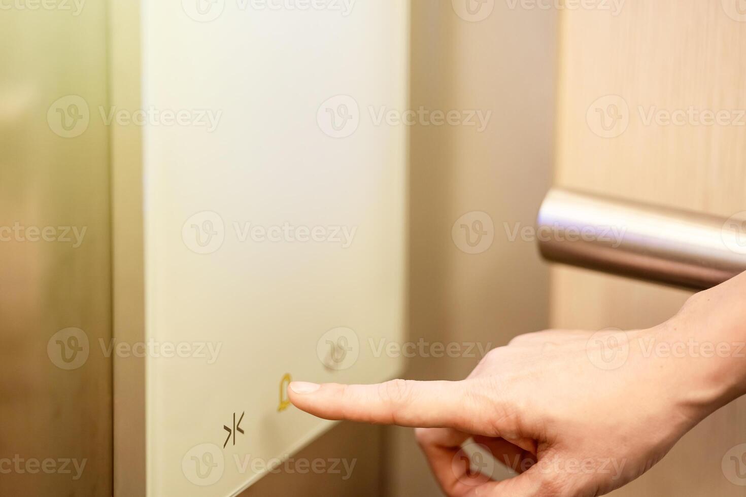 She is using her index finger to press the floor number that digital buttons in the elevator. photo