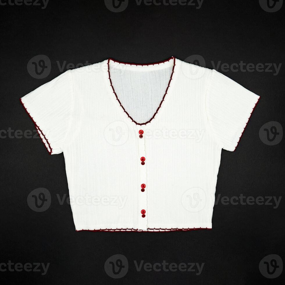 flat White knitwear sweater tshirt shape with red line on the rim on black background in studio light. photo
