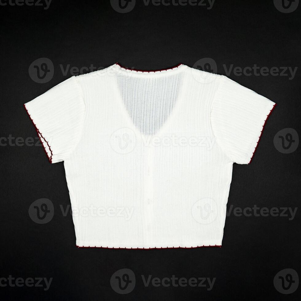 flat White knitwear sweater tshirt shape with red line on the rim on black background in studio light. photo