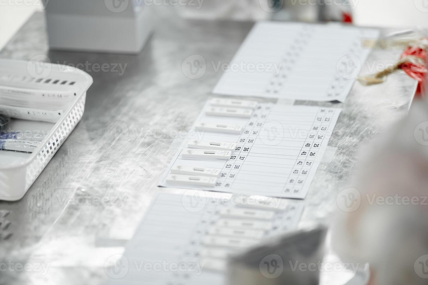 ATK results are place arranged on a paper number list on stainless silver table. photo