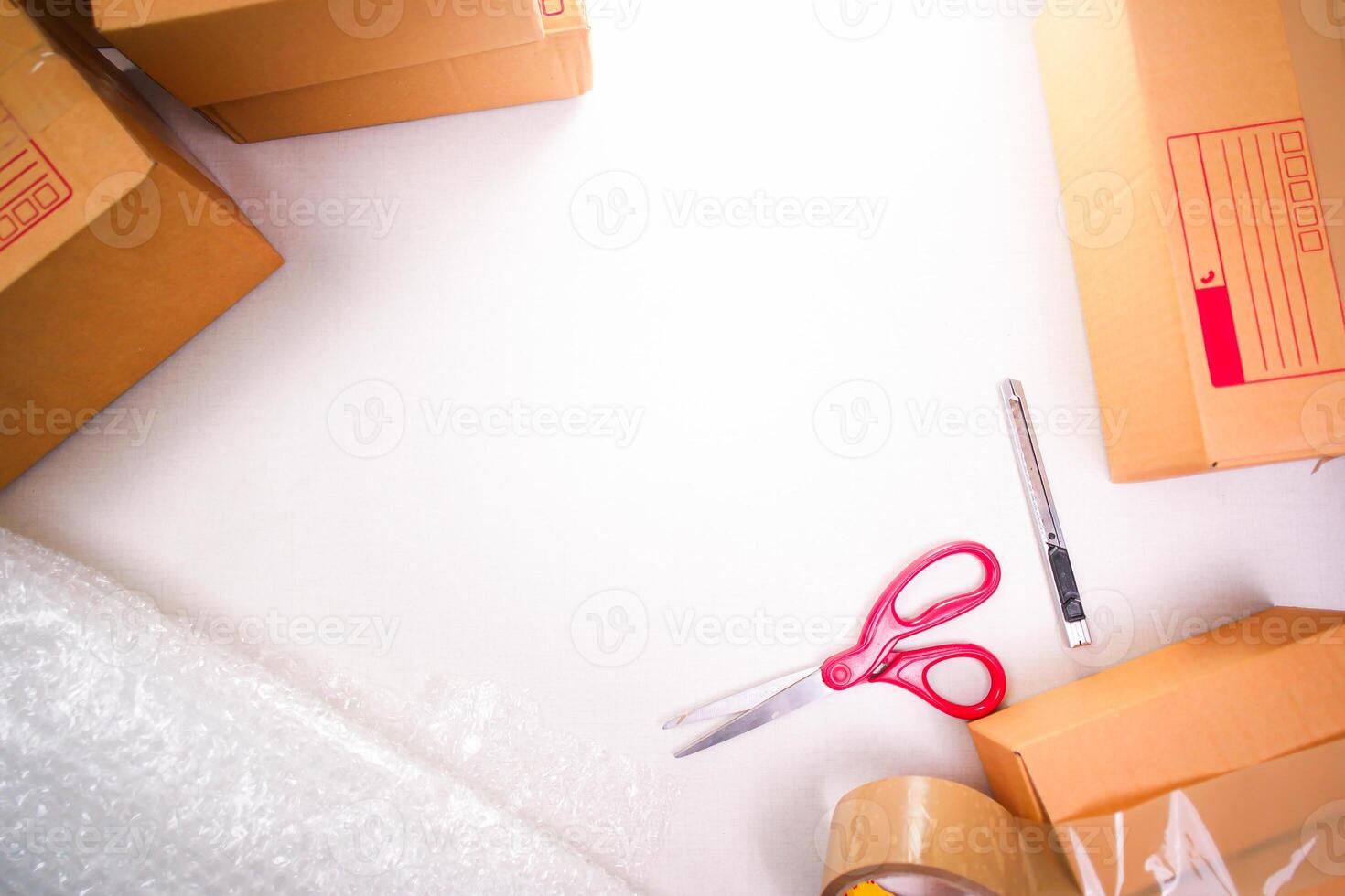 Goods delivery concept , cardboard boxes and product packaging equipment on white background with copy space for text , top view photo