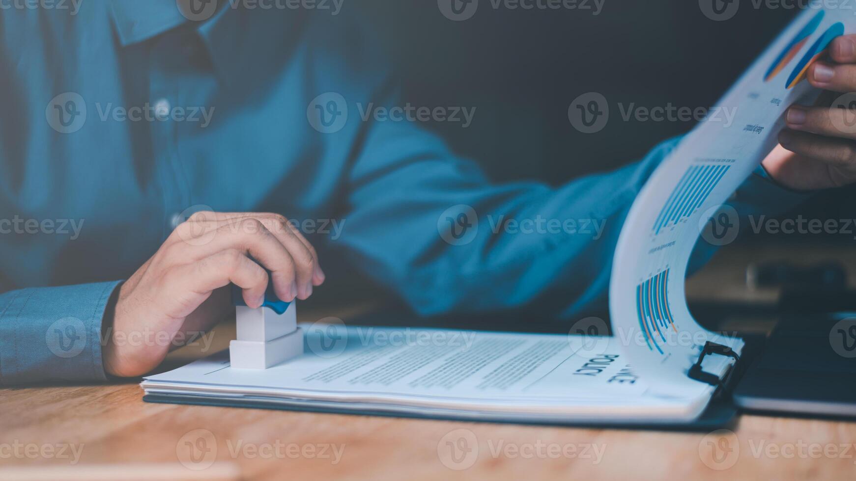 Businessman validates and manages business documents and agreements, signing a business contract approval of contract documents confirmation or warranty certificate,approval stamp photo
