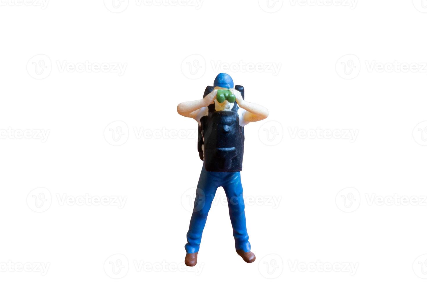 Miniature people A person holding binoculars up to their eyes isolate on white background photo