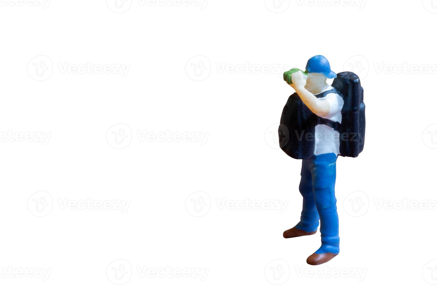 Miniature people A person holding binoculars up to their eyes isolate on white background photo