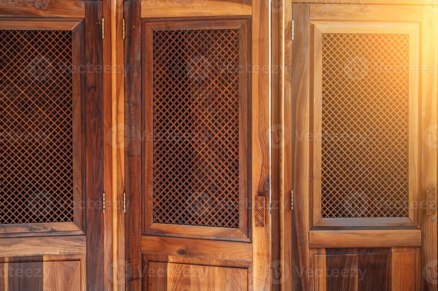 open wooden door with a lattice to the confessional for confession inside Catholic Cathedral photo