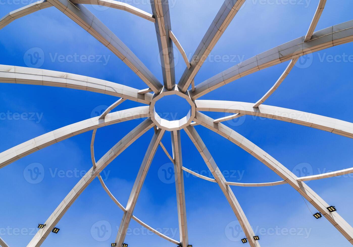 Metal construction of art object on background of blue sky background. Amphitheater in Navruz Park in Tashkent in Uzbekistan photo