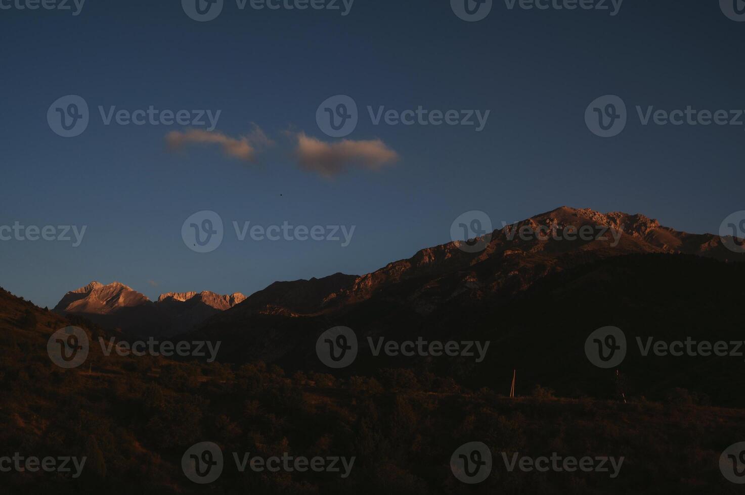 landscape with mountain peaks background sky with clouds at sunset in autumn photo