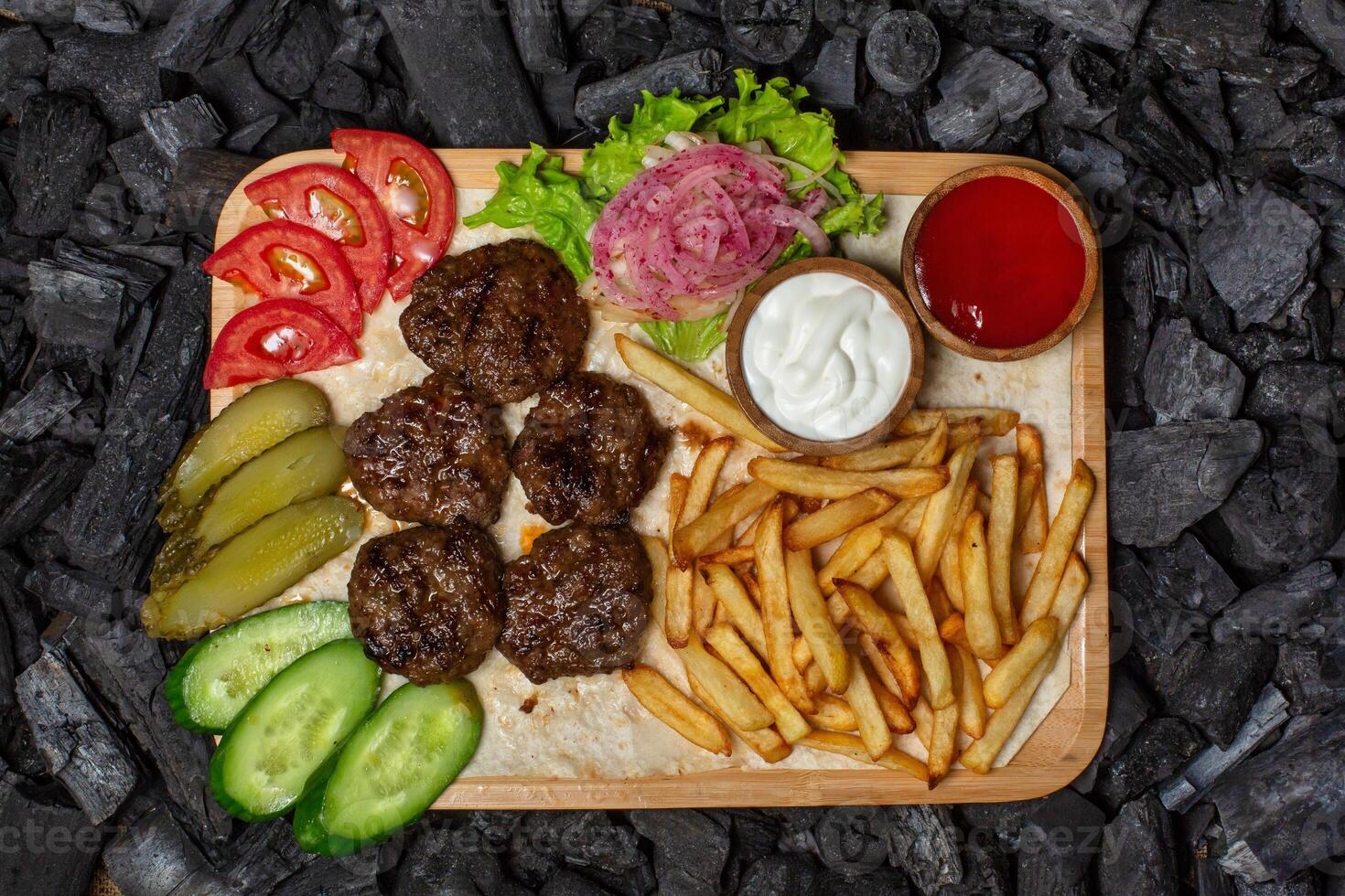 Grilled Meatballs With Fries and Sides photo
