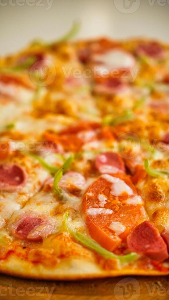 Close-Up of Pizza With Tomato and Sausage photo