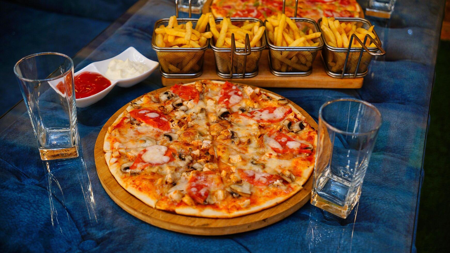 Pizza and Fries on a Blue Table photo