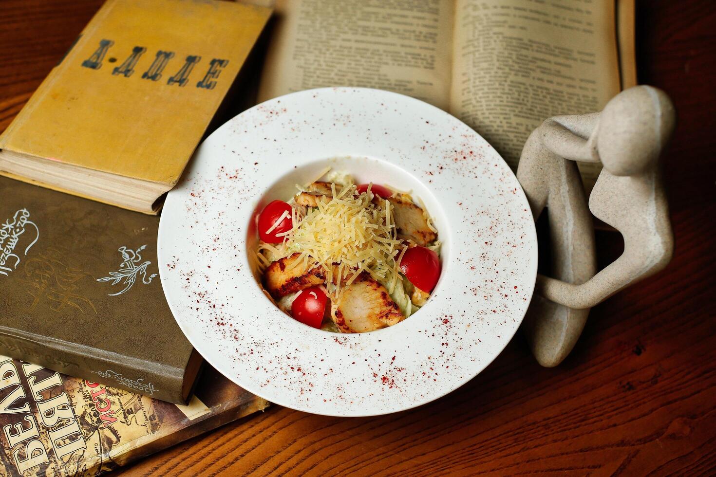 Caesar Salad With Chicken and Tomatoes on a White Plate photo