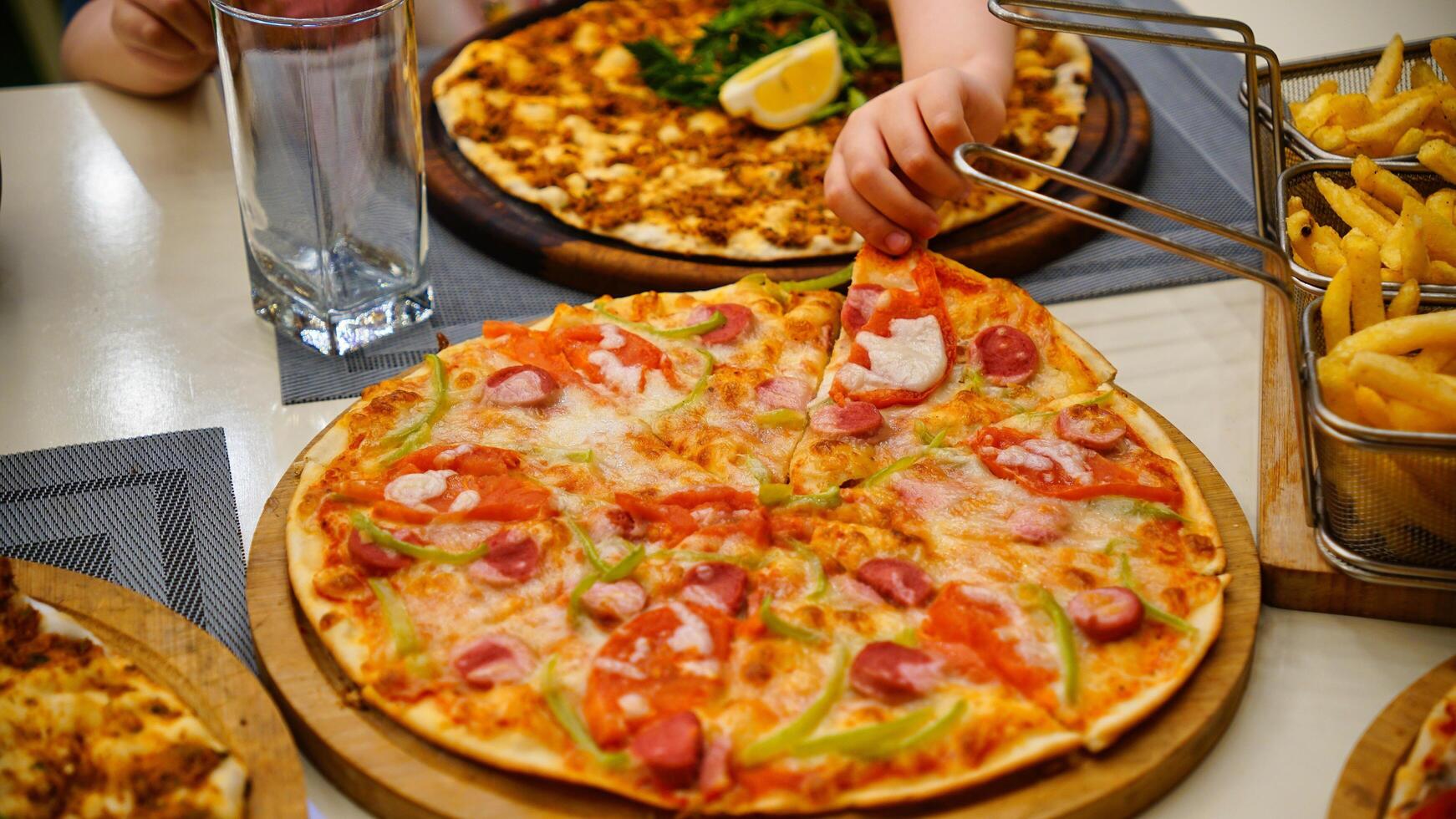 Pizza and Fries on a Table photo