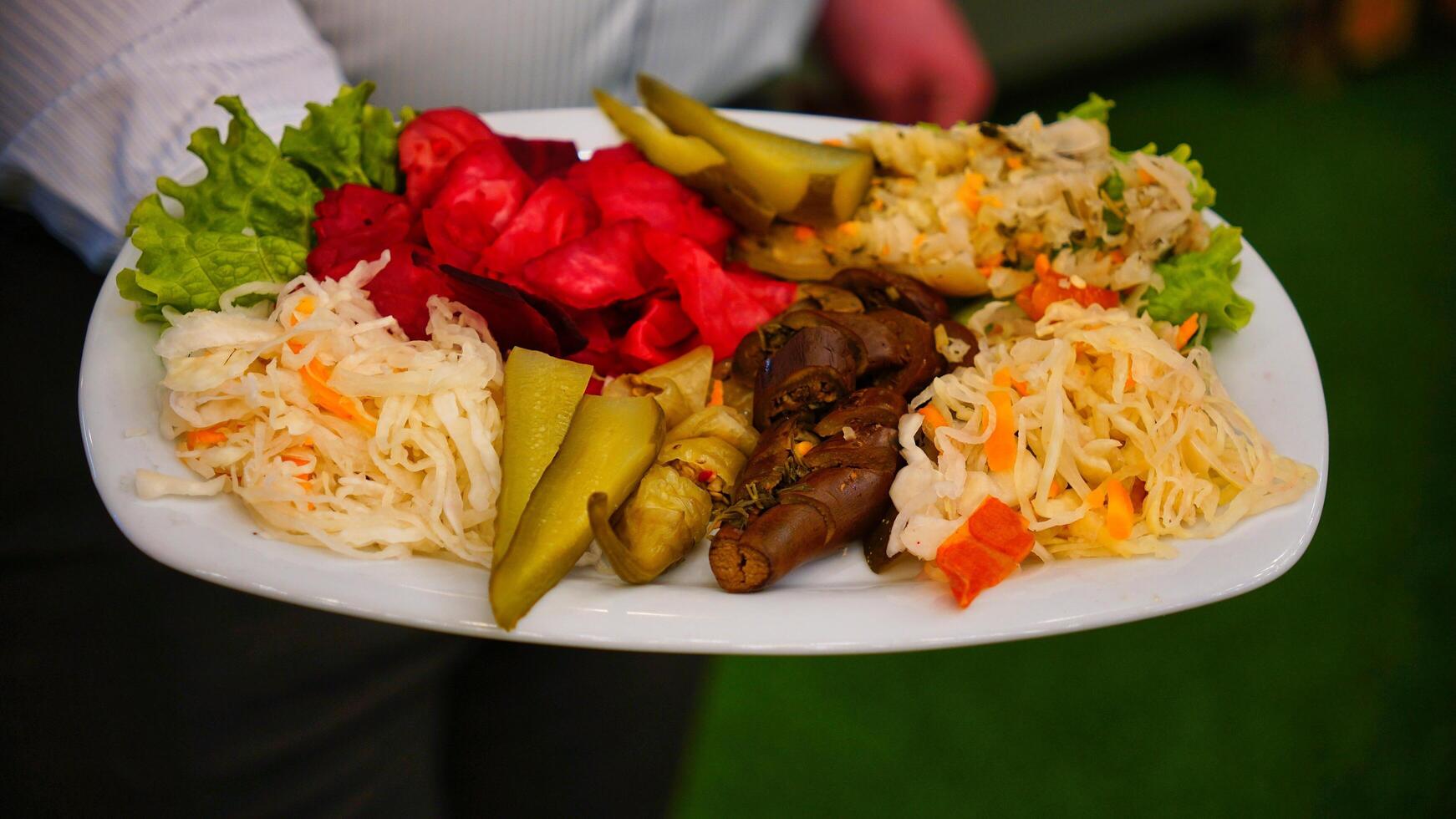 Assorted Pickles and Salads on White Plate photo