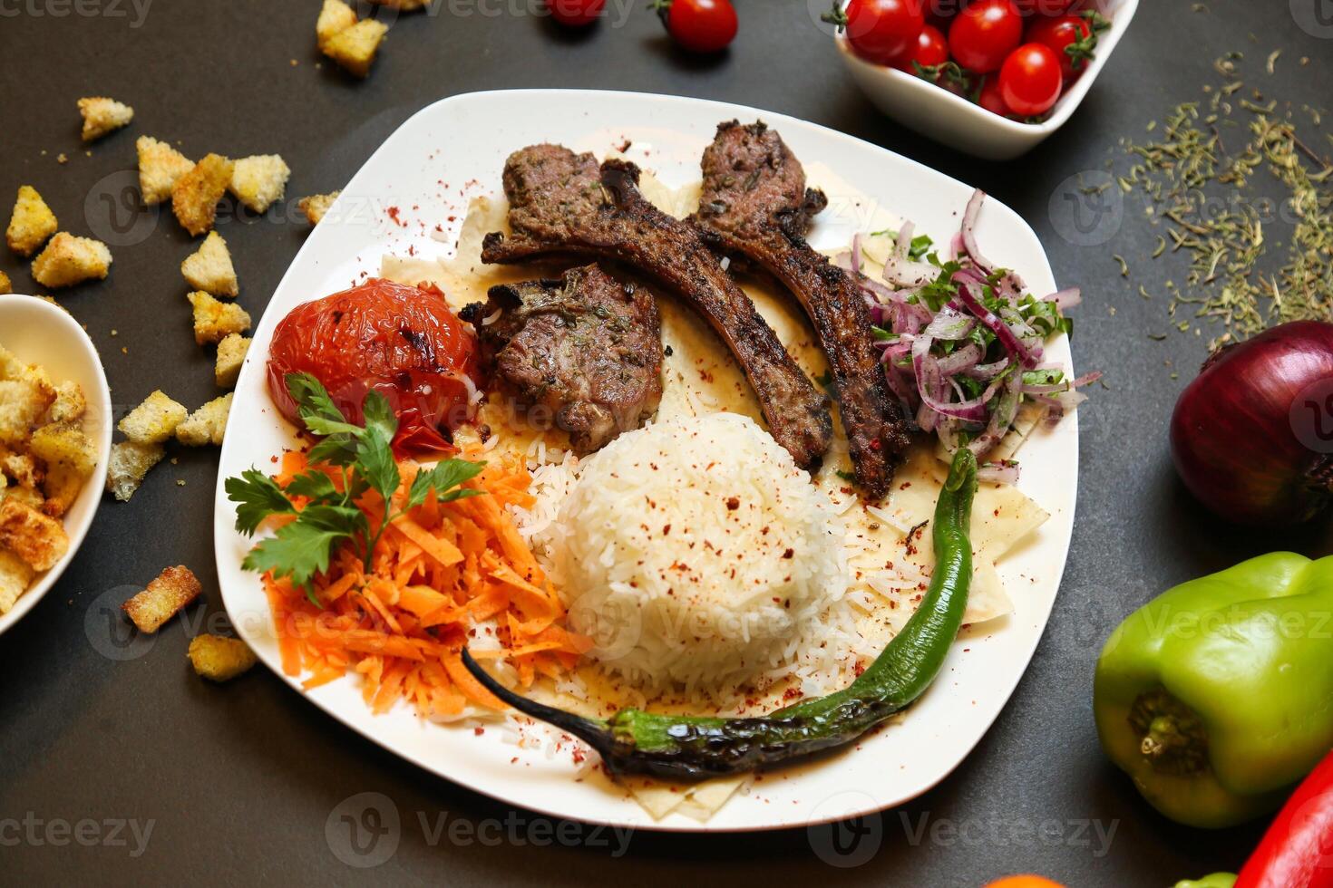 Grilled Lamb With Rice and Salad on a White Plate photo