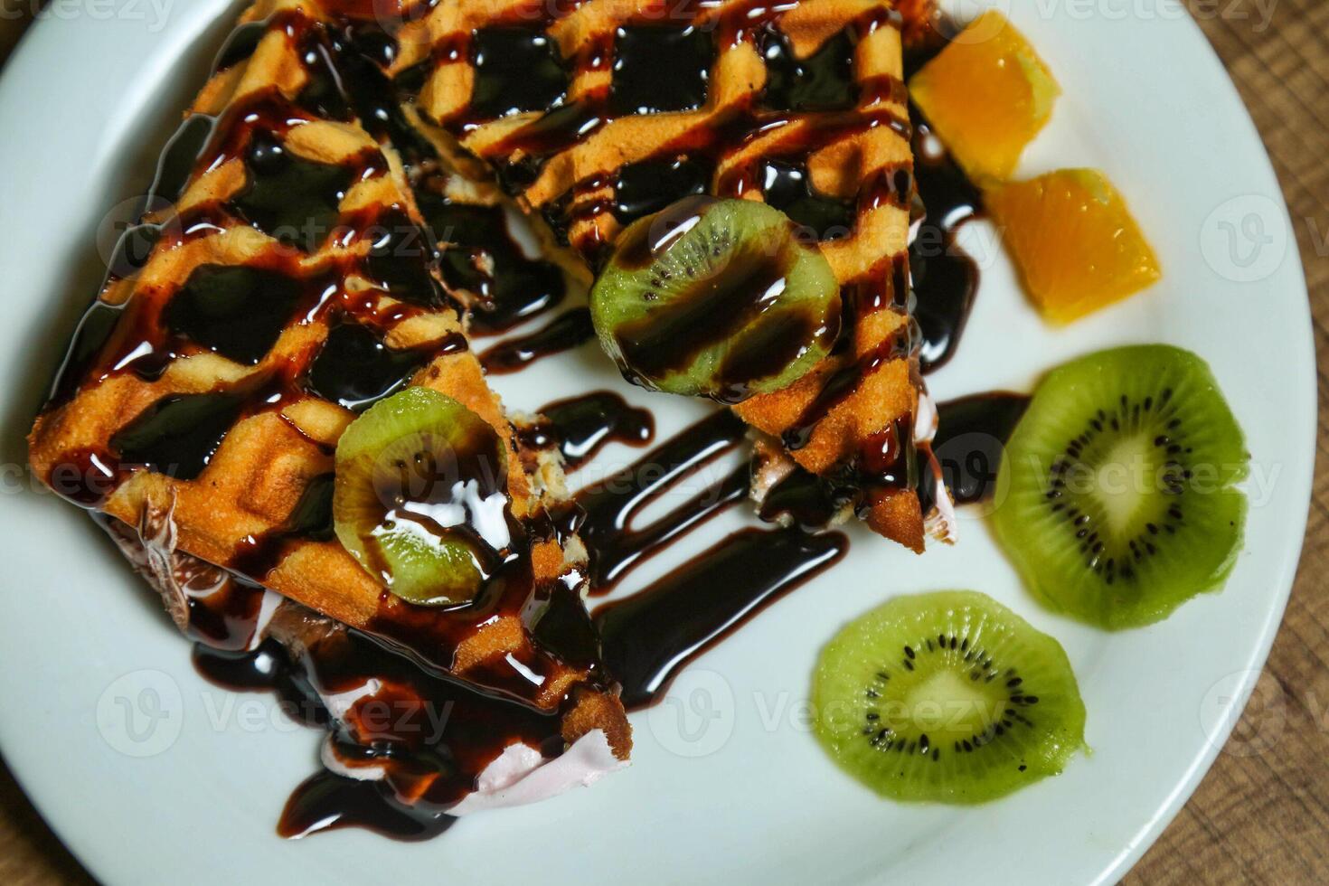 Chocolate Waffle With Kiwi and Orange Slices photo