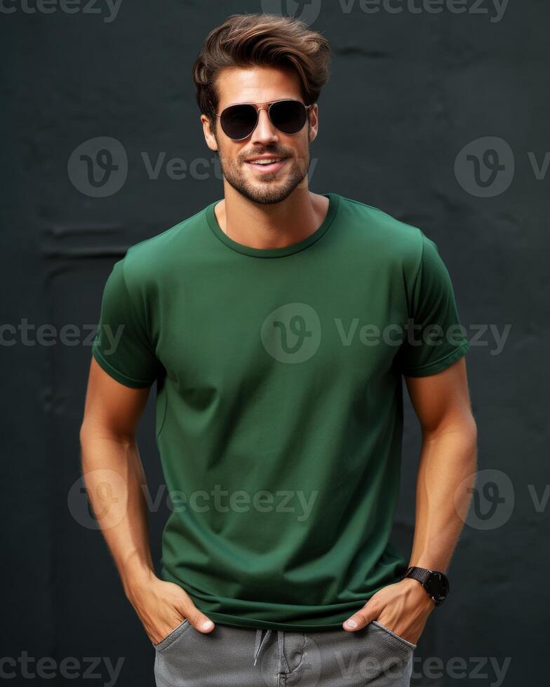 A man in sunglasses poses for a photo while wearing a blank green t-shirt
